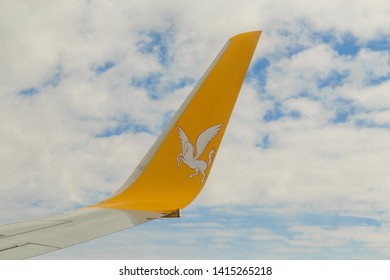 Istanbul, Turkey-may 04, 2019: International Airport Sabiha Gökçen International Airport,yellow Wing Passenger Aircraft In Flight In The Clouds, Pegasus Airline, Logo With A Horse