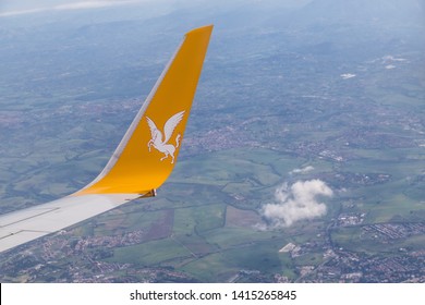 Istanbul, Turkey-May 04, 2019: International Airport Sabiha Gökçen International Airport,yellow Wing Passenger Aircraft In Flight In The Clouds, Pegasus Airline, Logo With A Horse