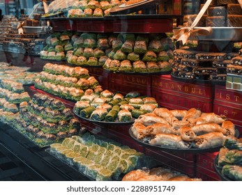 Istanbul. Turkish sweets in a grocery store window: a variety of baklava with pistachios and walnuts. Traditional Middle Eastern tastes. Assorted traditional Turkish desserts. No people