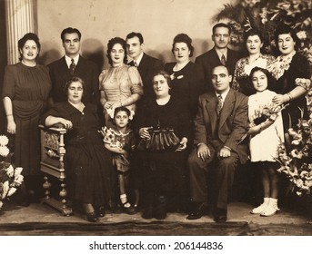 ISTANBUL-Turkey, Circa 1940s : Vintage Photo Of Newlyweds Posing With Their Family And Guests. 