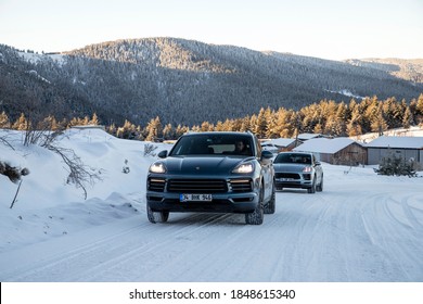 Istanbul/Turkey - February 25 2020 : Porsche Macan and Porsche Cayenne on the snow ways. They are climbing the mountain.