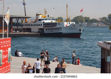  IstanbulTurkey May 17, 2022 Ferry leaves Karakoy Pier in Istanbul City, Beyoglu cityscape (Karaköy iskelesi)