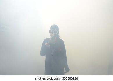 ISTANBUL,TURKEY,1 MAY 2014 A Protester Walking In Tear Gas Cloud With Gas Mask.