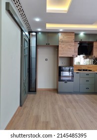 Istanbul,turkey-april 13 2022:parquet Floor, Green Kitchen Cabinets, Spotlights On The Ceiling, Elegant Kitchen