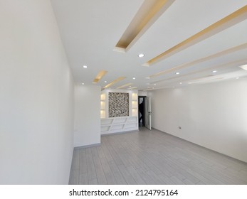 istanbul,turkey-february 17 2022:parquet living room with false ceilings with yellow spotlights