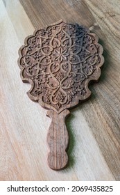 Istaravshan, Sughd Province, Tajikistan. August 19, 2021. Hand Carved Wooden Hand Held Mirror.