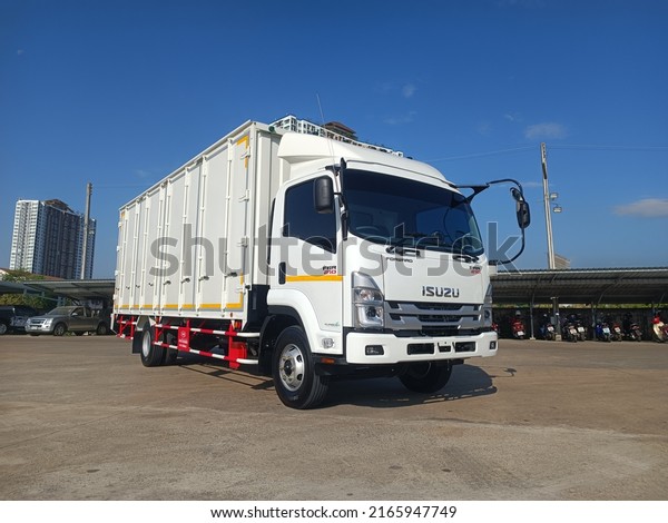 Isuzu trucks, cargo\
containers, 10 doors, in the parking lot - Thailand. Chiang Mai.\
March 24, 2022.