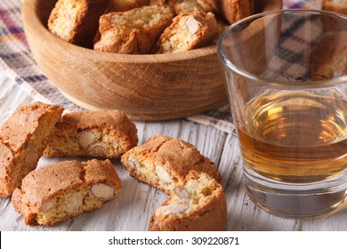 Italian almond biscotti biscuits and sweet wine in a glass closeup on the table. Horizontal