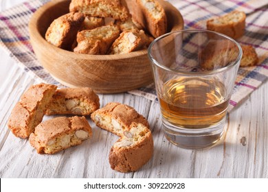 Italian almond biscotti biscuits and sweet wine in a glass on the table. Horizontal
