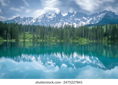 italian alps dolomites national park lake mountain trekking peaks tre cime brais lake carezza lake reflection clouds - Powered by Shutterstock