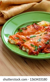 Italian American Baked Pasta Dish Stuffed Manicotti On Wooden Kitchen Table