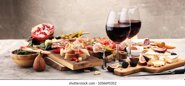 Italian antipasti wine snacks set. Cheese variety, Mediterranean olives, pickles, Prosciutto di Parma, pepper and salami - Powered by Shutterstock