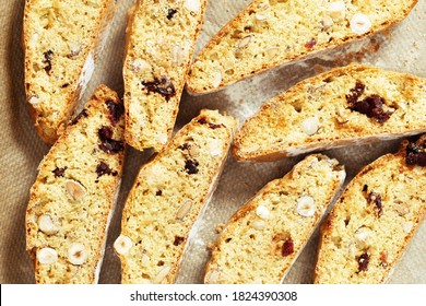 Italian biscotti cookies on baking paper. Nop view fresh baked cookies with nuts and dried cranberries.