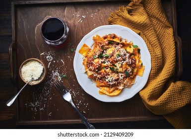 Italian bolognese sauce homemade papardelle pasta. Eating papardelle pasta with bolognese ragu sauce with parmesan cheese.