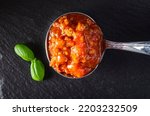 Italian bolognese sauce in spoon - top view