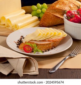 Italian Bread Slice With Slices Of Ham And Mozzarella Cheese On A Decorated Table.