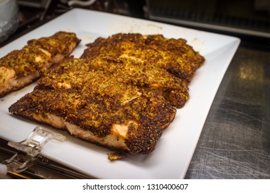 Italian Breaded Baked Salmon With Herbs And Spices Displayed In Glass Deli Case