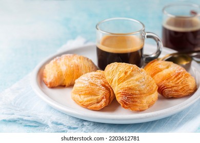 Italian Breakfast With Coffee. Caffè Espresso And Neapolitan Shell-shaped Pastry Sfogliatelle Riccia Stuffed With Ricotta, Almond Paste And Candied Peel Of Citron. Or Lobster Tail. Blue Background.