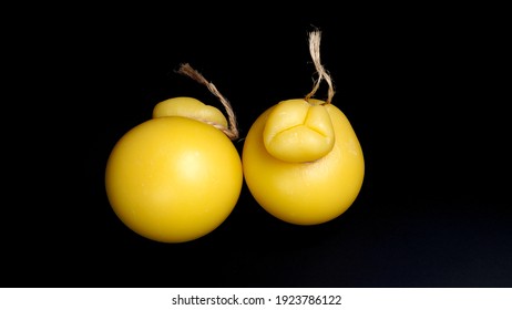 italian cacocavallo cheese on a black background