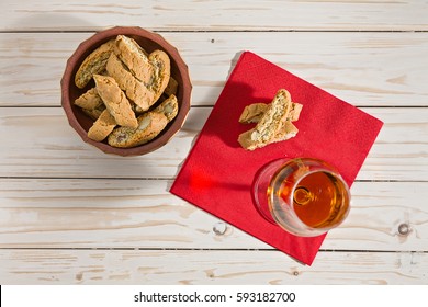 Italian cantucci biscuits and vin santo wine over a red napkin seen from above