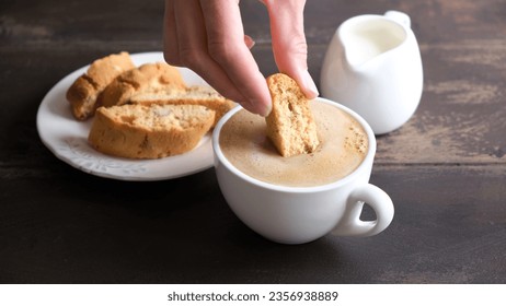 Italian Cantucci Cookie And Cup Of Cappuccino Coffee. Dipping Biscotti In Coffee