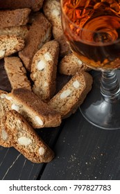 Italian cantuccini biscuits and a glass of sweet Vin Santo wine over wooden background
