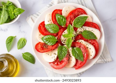 Italian caprese salad with sliced tomatoes, mozzarella, basil, olive oil - Powered by Shutterstock