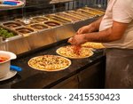 italian chef preparing pizza in a kitchen