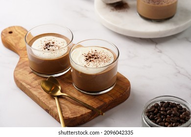 Italian chocolate and coffee mousse dessert semifreddo - half-frozen ice cream with whipped cream and cocoa powder in small glasses