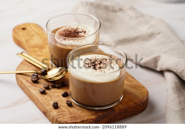 Italian chocolate and coffee mousse dessert\
semifreddo - half-frozen ice cream with whipped cream and cocoa\
powder in small glasses