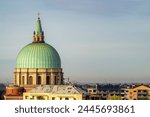 Italian city skyline under a morning spring sky. The ossuary temple dome (tempio ossario) in Udine city, Friuli Venezia Giulia region, Italy.