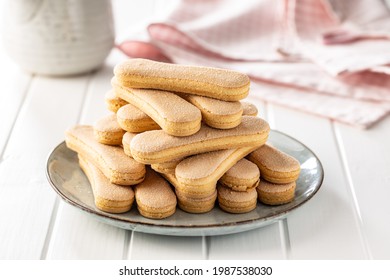 Italian cookie savoiardi. Sweet biscuits. Sponge cookies tiramisu on white table.