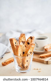 Italian cranberry almond biscotti  and cup of coffee on background