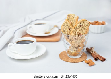 Italian cranberry almond biscotti and cup of coffee on background. Selective focus