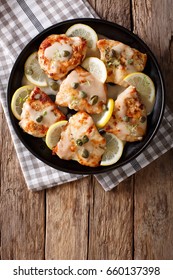 Italian Cuisine: Chicken Piccata With Sauce Close-up On The Table. Vertical View From Above
