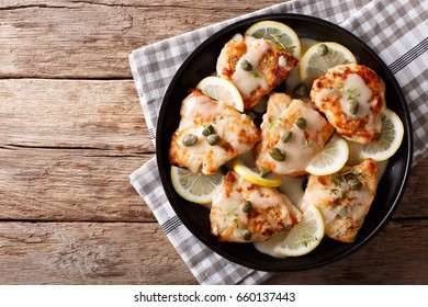 Italian Cuisine: Chicken Piccata With Sauce Close-up On The Table. Horizontal View From Above
