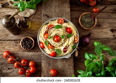 Italian cuisine. Pasta with olive oil, garlic, basil and tomatoes and tomato soup. - Powered by Shutterstock