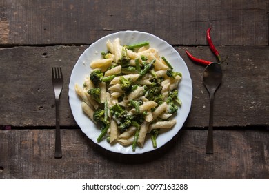 Italian Delicacy Penne Pasta In Cheese Sauce In A Plate. Top View.