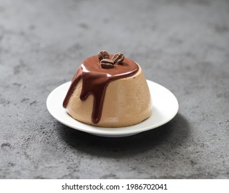 Italian dessert Panna Cotta creamy coffee with chocolate on a plate on a dark gray background