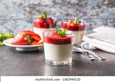 Italian dessert panna cotta in glass with strawberries.