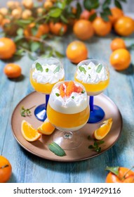 Italian dessert panna cotta with tangerine jelly layer in a glass