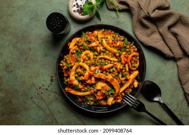 Italian Dinner With Cuttlefish Stew With Peas And Tomatoes Or Seppie Con Piselli. On Green Table Surface.