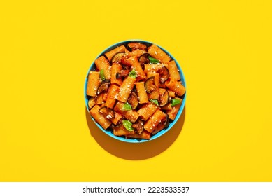 Italian dish, pasta with deep-fried eggplant, top view on a yellow-colored table. Pasta Alla Norma plate minimalist on a colorful background in bright light - Shutterstock ID 2223533537
