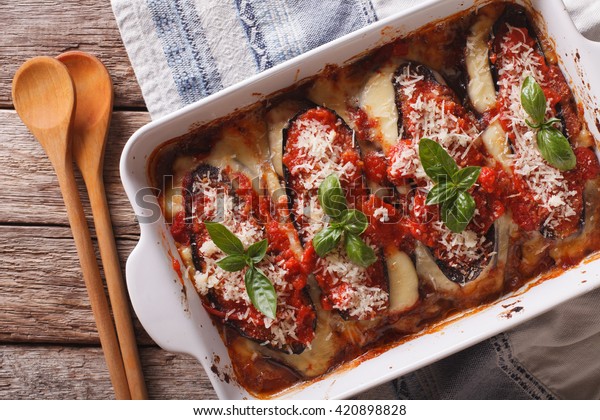 Italian eggplant\
Melanzane alla parmigiana close up in baking dish on the table.\
horizontal view from\
above\
