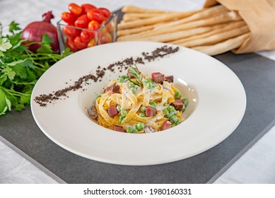 Italian Fettuccine Carbonara With Green Peas In A White Plate