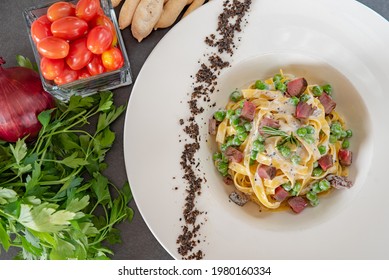 Italian Fettuccine Carbonara With Green Peas In A White Plate