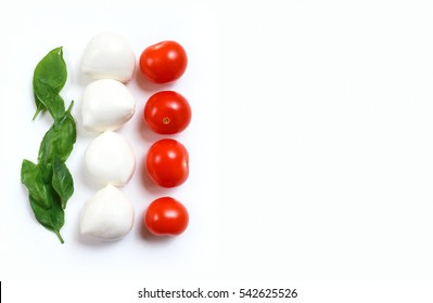 Italian flag made of food concept. Italian caprese salad made of cherry mozzarella, basil leaves and cherry tomatoes on white background. Empty copy space for inscription