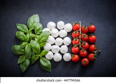 Italian flag made of fresh food on dark slate