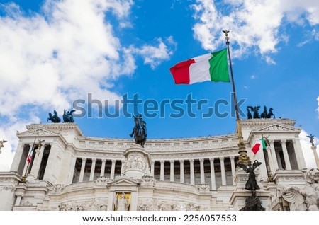 Italian flag on Vittoriano building, Rome, Italy. This monument is landmark of Italy. Sunny view of flag at Capitol hill on Venice Square. Nice scenery