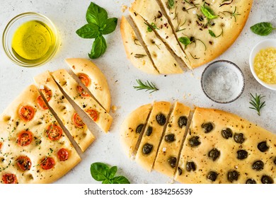 Italian Focaccia Bread with various vegetable filling. Fresh baked focaccia with tomatoes, olives, garlic and herbs, top view. - Powered by Shutterstock